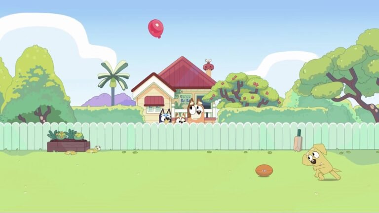 From the Bluey episode 'Keepy Uppy': Socks the puppy runs across the grass toward a football while Bluey and Bingo peek over the fence. A red balloon floats above the house, and a cricket bat leans against the fence.